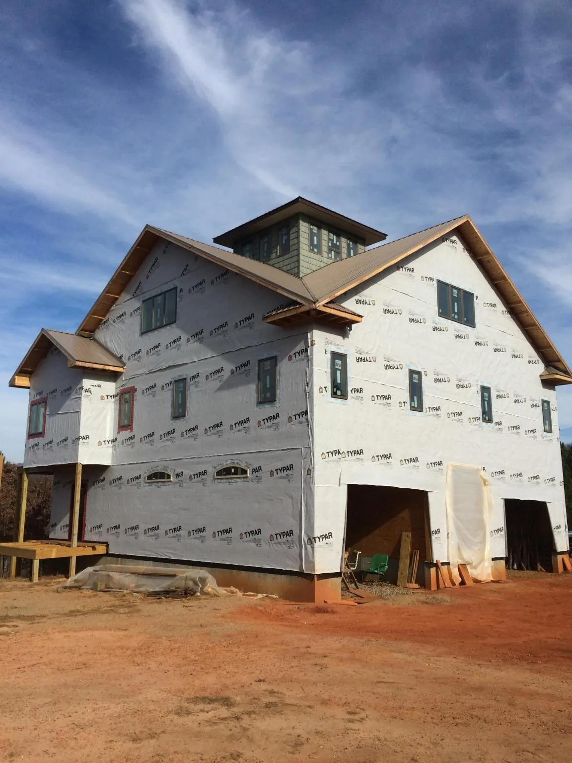 New two story house under construction with a cupola and gabled roofs in Mountainside